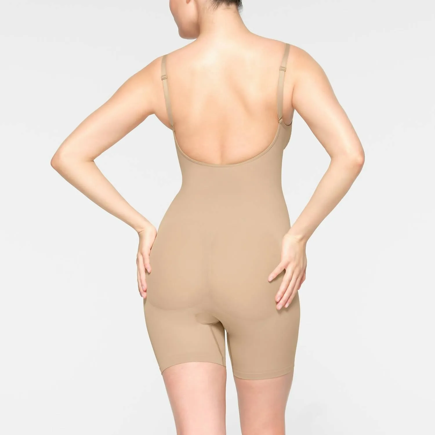 Nahtlos geschnittenes Bodysuit mit tiefem Rücken und mittlerer Oberschenkellänge in Lehm